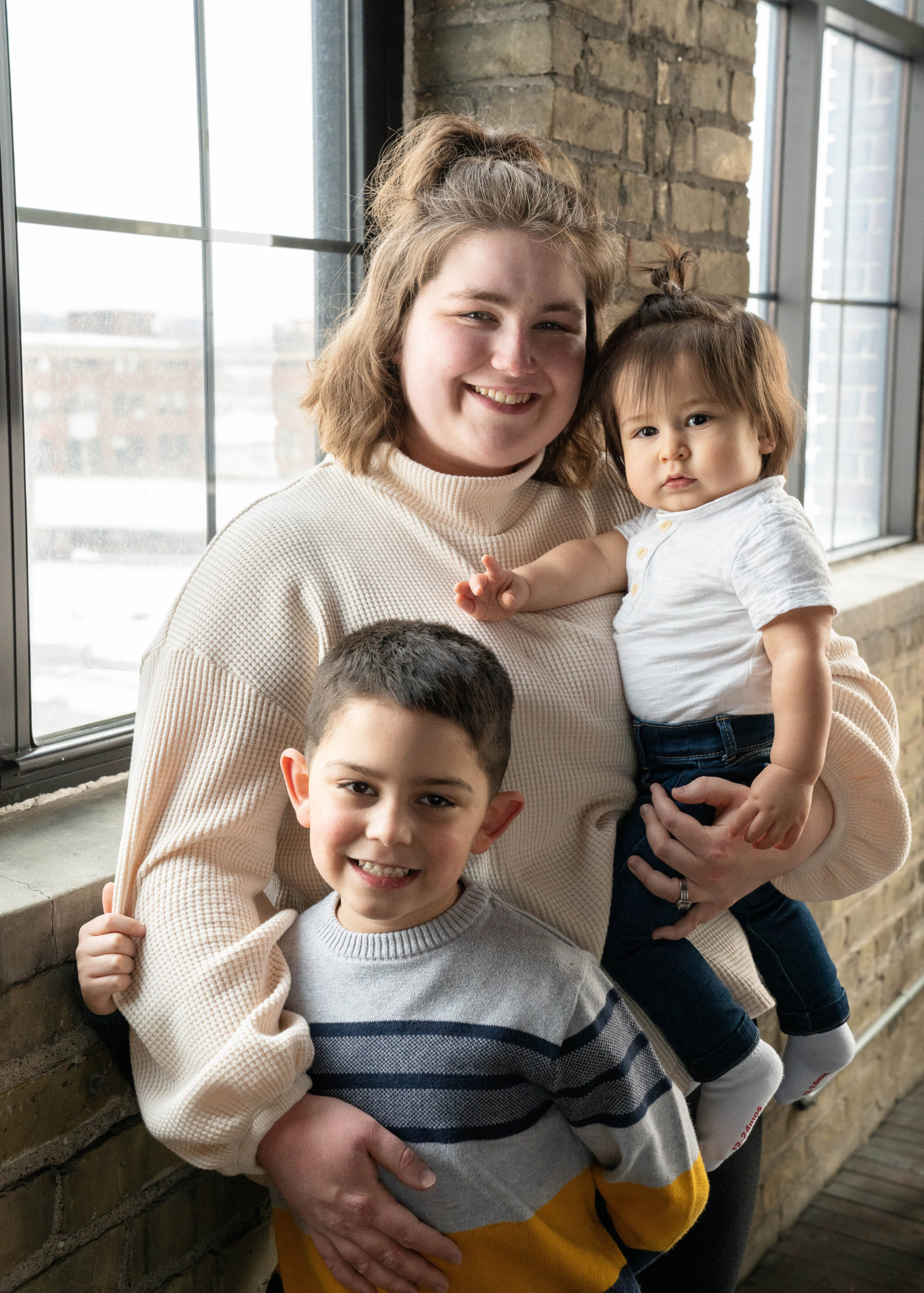 Mother poses with her sons - family session