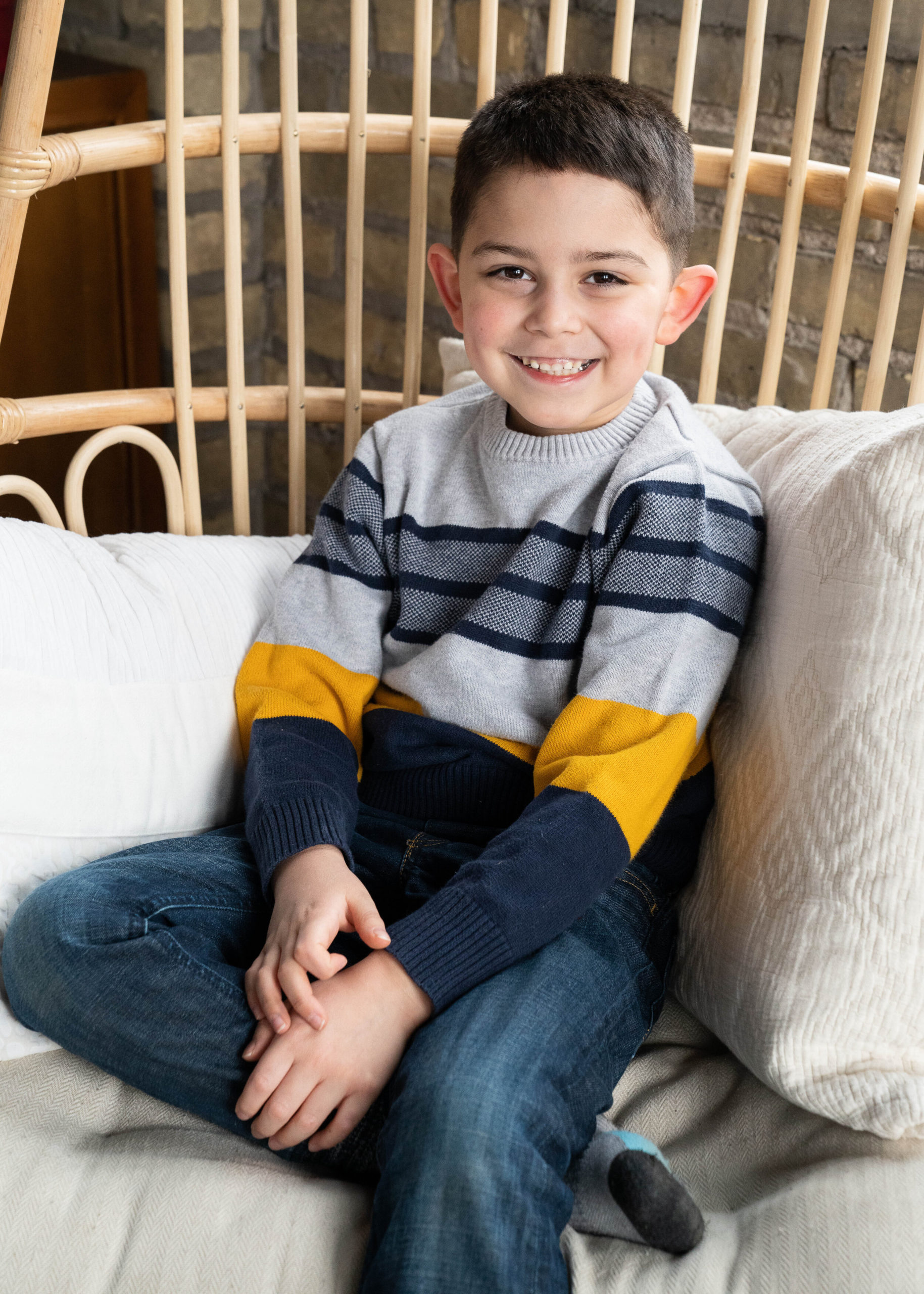 Little boy sitting in a chair smiling - family session