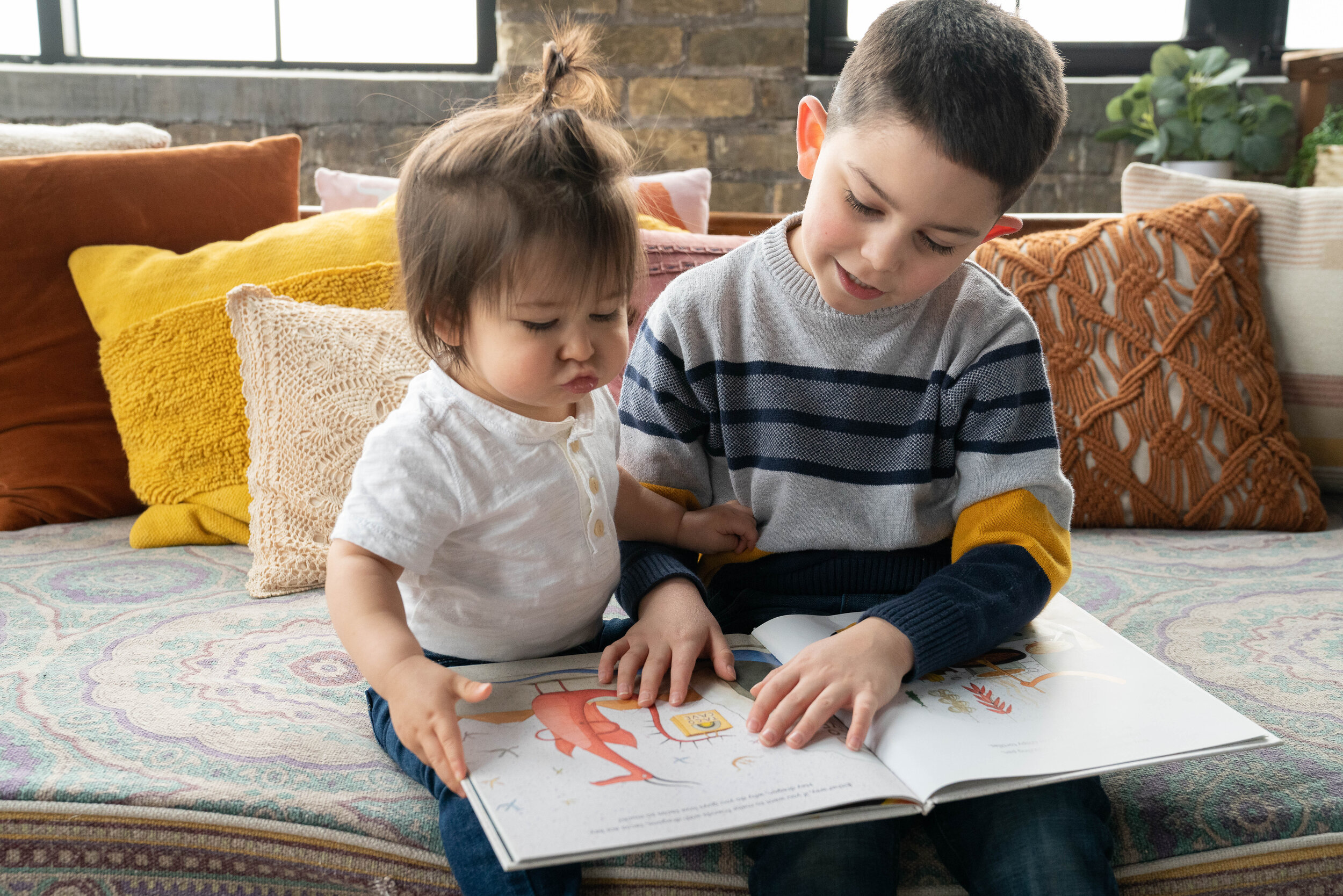 Big brother reads to his little brother - family session