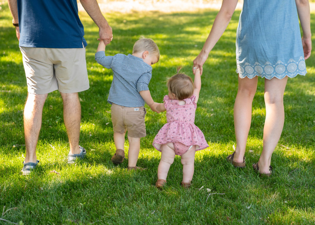 Family of 4 walking in the grass