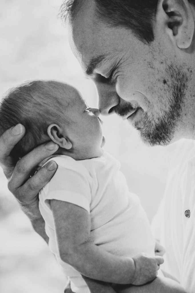 Alec showing his daughter some love during their in-home newborn session. 
