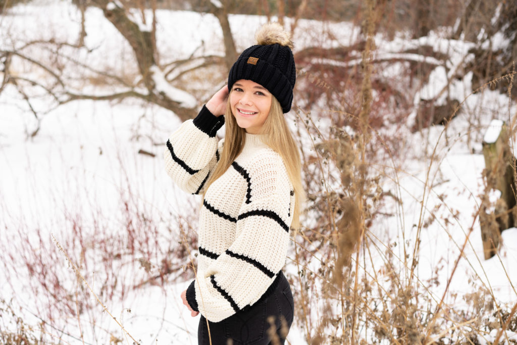 Girl posing in the snow for her senior photos