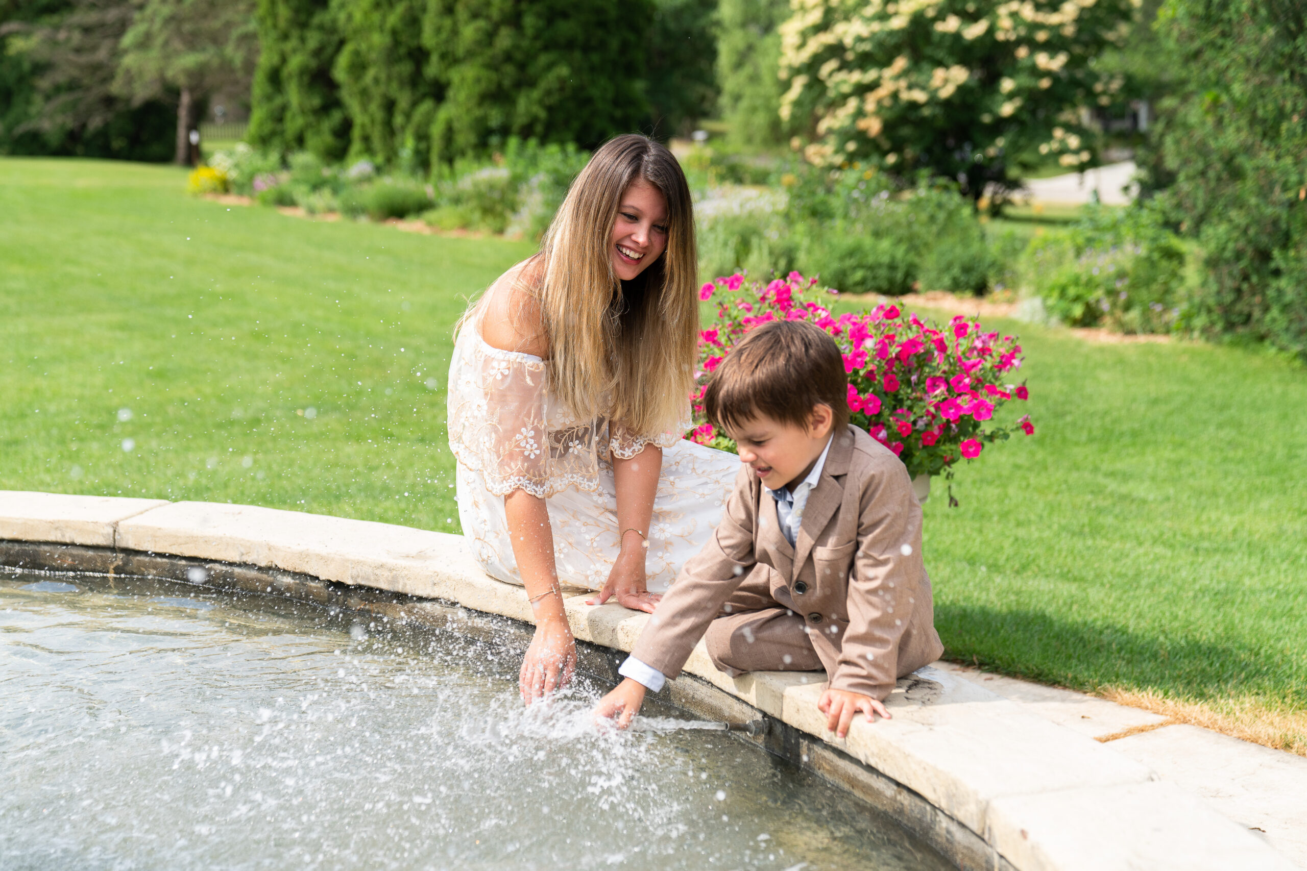 A mother and her son playing in the fountain at Arneson Acres Park in Edina, Minnesota.