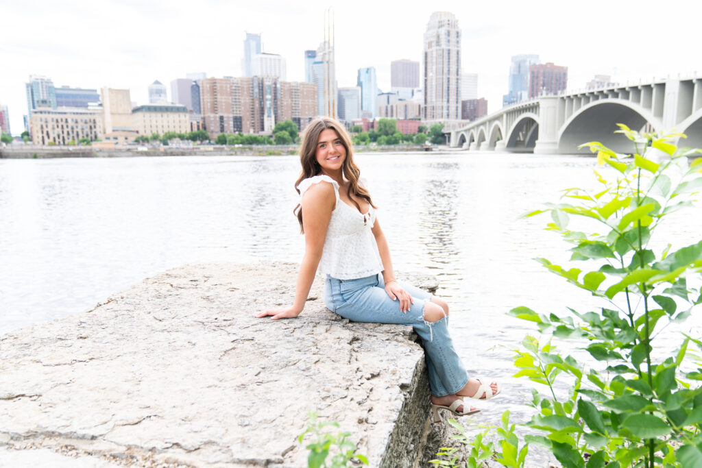 A girl poses for her senior pictures overlooking the Minneapolis skyline - Kristen Elizabeth Photography