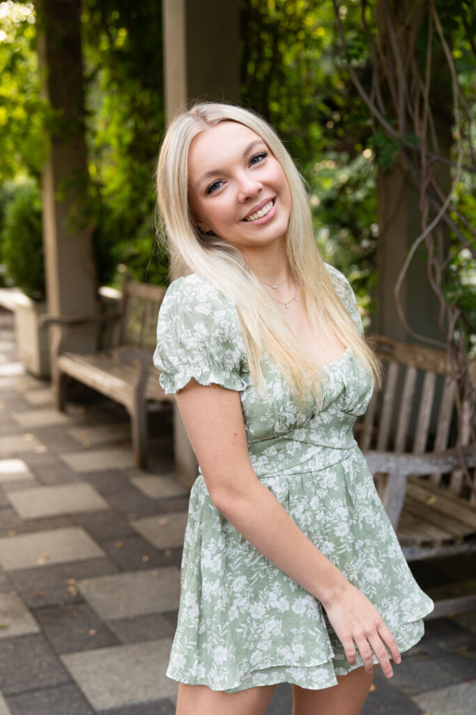 A high school senior girl sways back and forth during her senior session at the Minnesota Landscape Arboretum.