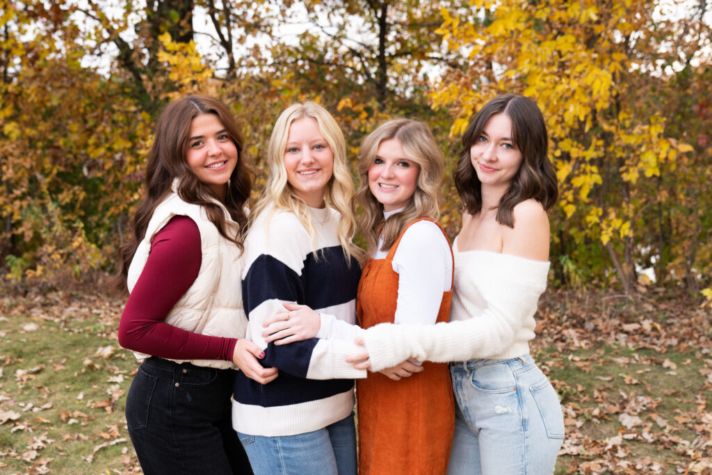 Four teen girls pose together during their fall senior rep photo shoot.